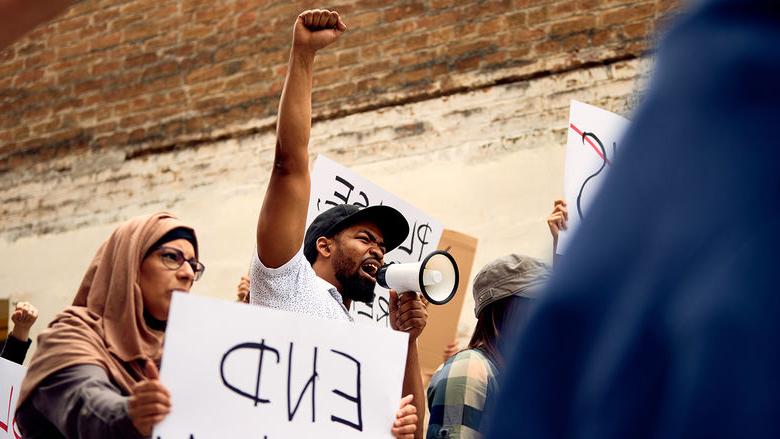 A group of diverse individuals protest racism